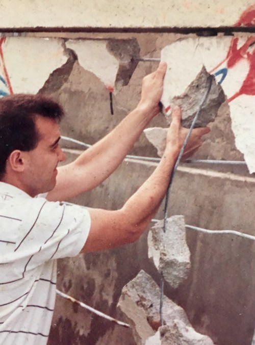 tearing down piece of Berlin Wall